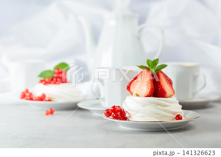 Pavlova dessert with strawberries, red currant, and mint. Pavlova dessert with strawberries, red currant, and mint. 141326623