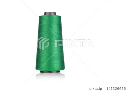 spool of industrial thread green color, texture of thread on a white background spool of industrial thread green color, texture of thread on a white background 141326636