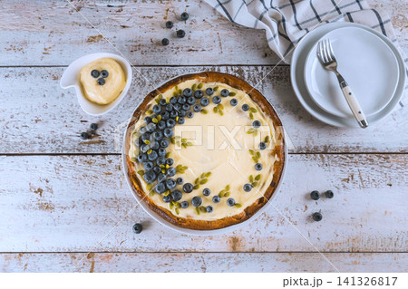 Blueberry dessert with cream on wooden table at kitchen setting Blueberry dessert with cream on wooden table at kitchen setting 141326817