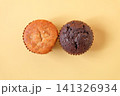Two cup cakes home made on color background. 141326934