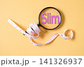 A measuring tape around magnifying glass and text SLIM . 141326937