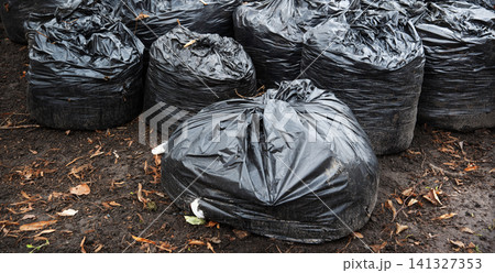 Many garbage bags in the park 141327353