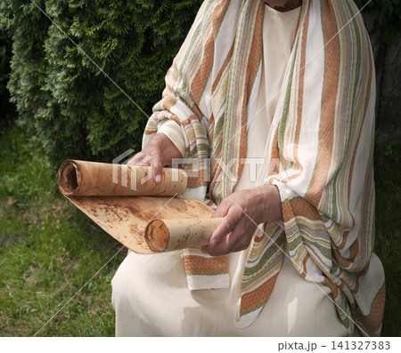 Old man reading the scroll Old man reading the scroll 141327383