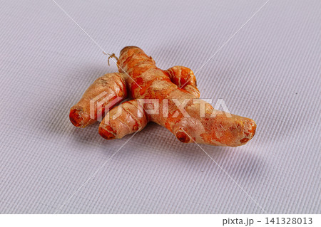 Fresh turmeric root on white textured surface Fresh turmeric root on white textured surface 141328013