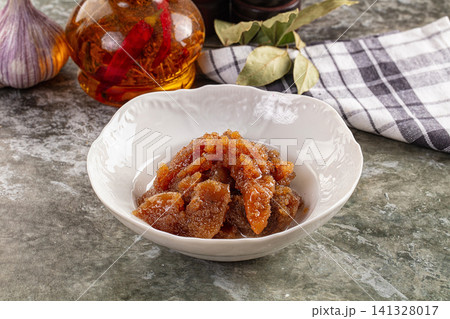 Caviar in white bowl with garlic and spice oil on rustic stone surface Caviar in white bowl with garlic and spice oil on rustic stone surface 141328017