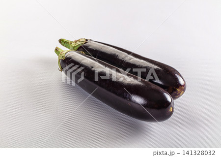 Two fresh eggplants on white textured surface Two fresh eggplants on white textured surface 141328032