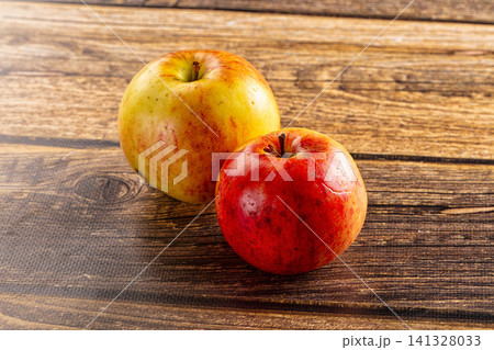 Two fresh apples on rustic wooden surface Two fresh apples on rustic wooden surface 141328033