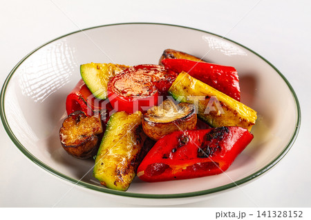 Grilled vegetables in white bowl with green rim Grilled vegetables in white bowl with green rim 141328152