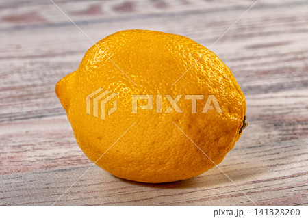 Fresh yellow lemon on rustic wooden surface Fresh yellow lemon on rustic wooden surface 141328200