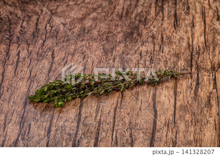 Fresh thyme sprig on rustic wooden surface Fresh thyme sprig on rustic wooden surface 141328207