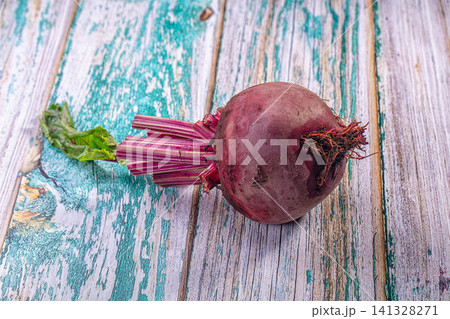 Fresh beetroot with leafy stems on rustic weathered wooden surface 141328271