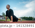 young athlete push up and plank at stadium outdoor 141328491