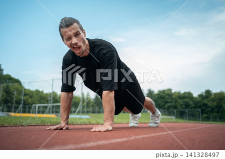 athletic sportsman has workout and planking outdoor athletic sportsman has workout and planking outdoor 141328497