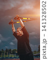 yound sporty athlete or bodybuilder has fitness workout with trx outdoor 141328502