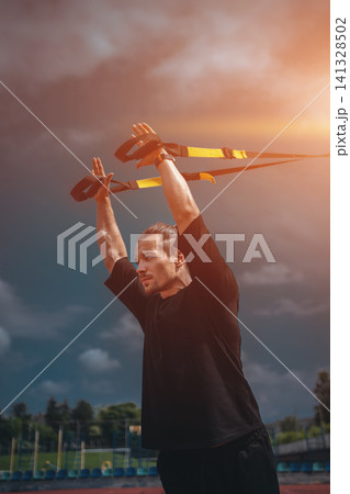 yound sporty athlete or bodybuilder has fitness workout with trx outdoor yound sporty athlete or bodybuilder has fitness workout with trx outdoor 141328502