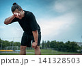 tired and exhauster runner on sport track outdoor 141328503