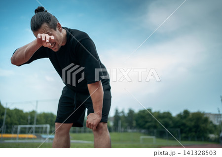 tired and exhauster runner on sport track outdoor tired and exhauster runner on sport track outdoor 141328503