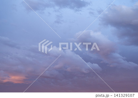 A soft pastel evening sky after a storm with clouds floating above the horizon. A soft pastel evening sky after a storm with clouds floating above the horizon. 141329107