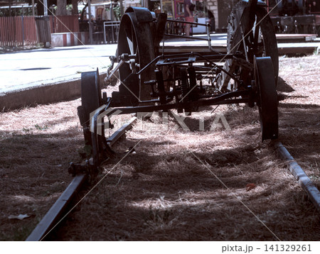 a small cart stands near the wheelchair a small cart stands near the wheelchair 141329261