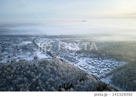 Aerial view of vehicle open market lot with many cars for sale parked and people customers walking in winter Aerial view of vehicle open market lot with many cars for sale parked and people customers walking in winter 141329392