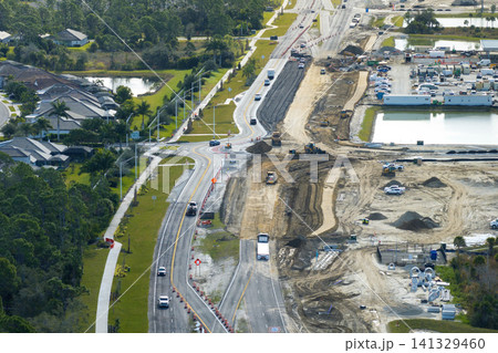 Aerial view of busy American highway road under construction. Development of traffic infrastructure. State transportation concept Aerial view of busy American highway road under construction. Development of traffic infrastructure. State transportation concept 141329460