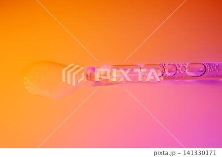Clear serum dripping from pipette for skin care Clear serum dripping from pipette for skin care 141330171
