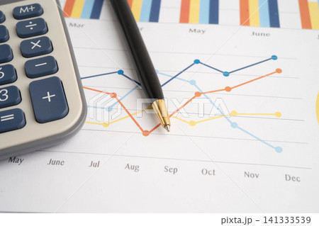 Calculator on chart graph paper. Finance, account, statistic, investment data economy, stock exchange business. Calculator on chart graph paper. Finance, account, statistic, investment data economy, stock exchange business. 141333539