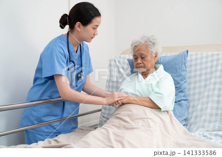 Asian doctor checking and treat elderly woman patient health in hospital. Asian doctor checking and treat elderly woman patient health in hospital. 141333586
