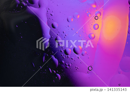 Oil and water creating an abstract background with colorful flowing fluid and floating bubbles 141335143