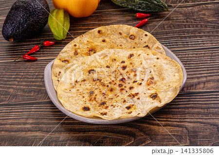 Toasted flatbreads with avocado starfruit and chili peppers on rustic wood Toasted flatbreads with avocado starfruit and chili peppers on rustic wood 141335806