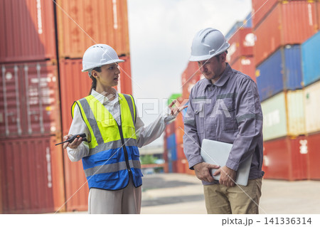 Female manager scolding and mad at foreman worker at container ship yard. Mistake and error in import-export business. 141336314