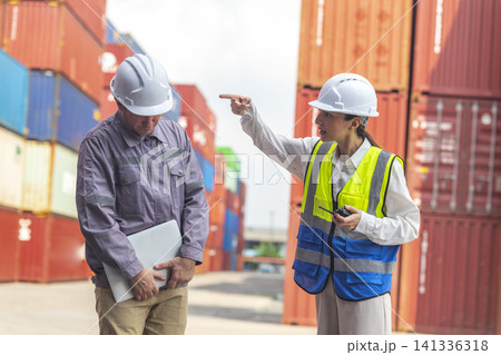 Female manager scolding and mad at foreman worker at container ship yard. Mistake and error in import-export business. Female manager scolding and mad at foreman worker at container ship yard. Mistake and error in import-export business. 141336318