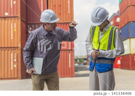 Female manager scolding and mad at foreman worker at container ship yard. Mistake and error in import-export business. Female manager scolding and mad at foreman worker at container ship yard. Mistake and error in import-export business. 141336406