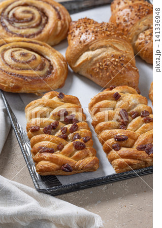 Pan of Various Freshly Baked Sweet Buns on beige table Pan of Various Freshly Baked Sweet Buns on beige table 141336948