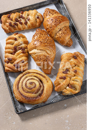 Pan of Various Freshly Baked Sweet Buns on beige table Pan of Various Freshly Baked Sweet Buns on beige table 141336950