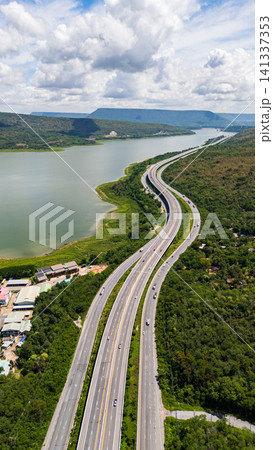 Drone shot The M6 motorway Nakhon Ratchasima Province - Bang Pa-in Lam Ta Khong River and Mountain. Motorway Korat Thailand Drone shot The M6 motorway Nakhon Ratchasima Province - Bang Pa-in Lam Ta Khong River and Mountain. Motorway Korat Thailand 141337353