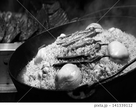 Aromatic pilaf is fried in a cauldron Aromatic pilaf is fried in a cauldron 141339112