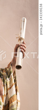 Male hand holding an old scroll Male hand holding an old scroll 141339138
