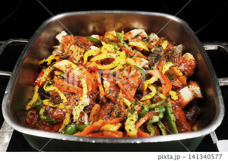 Stir-fried pork with red curry paste, bell peppers and spur chilies in aluminum tray. Traditional of Thai food Stir-fried pork with red curry paste, bell peppers and spur chilies in aluminum tray. Traditional of Thai food 141340577