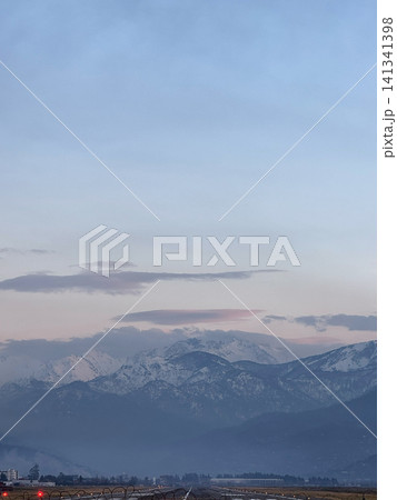 Snowy mountain ridges of the Caucasus near Batumi, Georgia seen at dusk with fading pink light reflecting on peaks Snowy mountain ridges of the Caucasus near Batumi, Georgia seen at dusk with fading pink light reflecting on peaks 141341398
