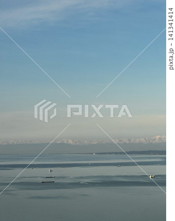 Cargo ships and boats on calm Black Sea near Batumi with distant mountains Cargo ships and boats on calm Black Sea near Batumi with distant mountains 141341414