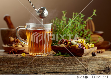 Herbal tea with ingredients on a old wooden table. 141341561