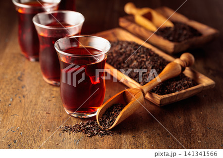 Black tea on an old wooden table. Black tea on an old wooden table. 141341566