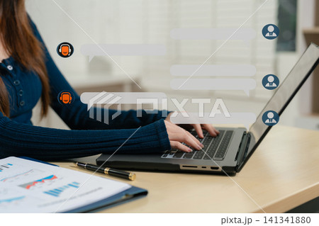 Stylish woman works in digital marketing, typing on laptop and smartphone at office desk. Social media, business. Stylish woman works in digital marketing, typing on laptop and smartphone at office desk. Social media, business. 141341880