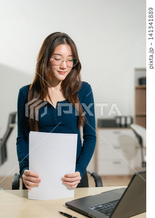 Businesswomen hand working with tablet and laptop computer with documents on office desk in modern office. Businesswomen hand working with tablet and laptop computer with documents on office desk in modern office. 141341889