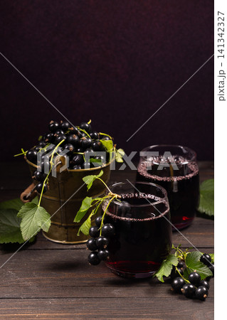 Fresh blackcurrants and natural berry juice on rustic table Fresh blackcurrants and natural berry juice on rustic table 141342327