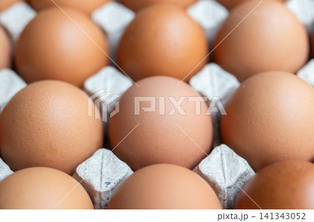 Fresh organic brown chicken eggs in cardboard tray Fresh organic brown chicken eggs in cardboard tray 141343052