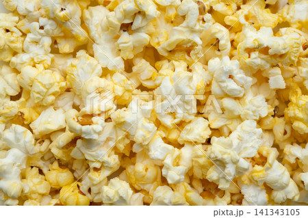 Tasty popcorn close up background top view Tasty popcorn close up background top view 141343105