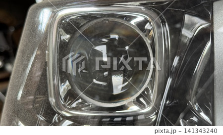 Close-up of Dusty Car Headlight Lens with Reflective Light Details Close-up of Dusty Car Headlight Lens with Reflective Light Details 141343240