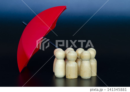 Group of followers receiving umbrella protection representing effective leadership and risk management. 141345881